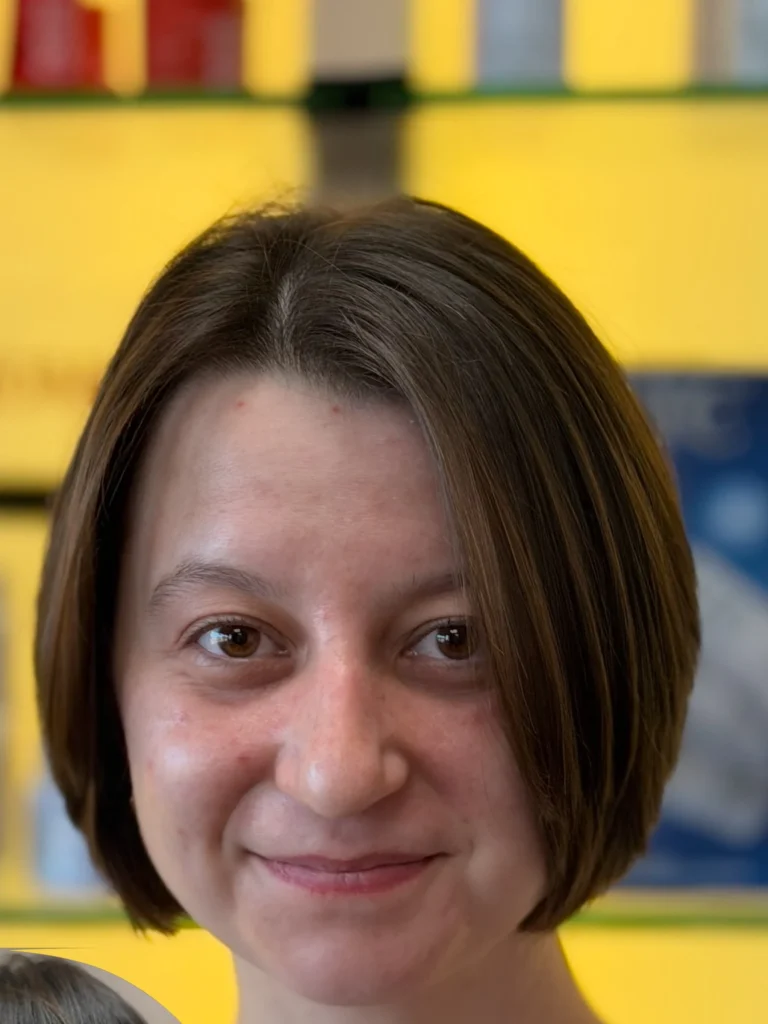 Chic French bob haircut at jaw length on a smiling woman in a salon