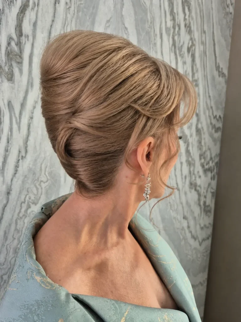 Elegant French twist roll on a mature woman with drop earrings