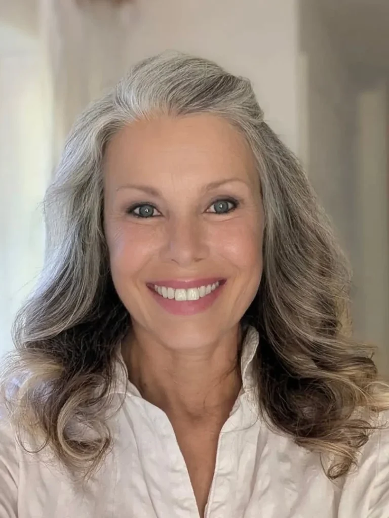 Middle-aged woman with long silver grey wavy hair