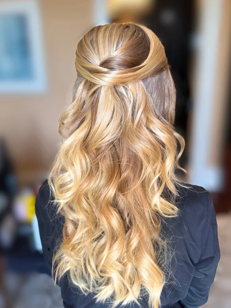 Half-up twisted crown with long blonde soft curls