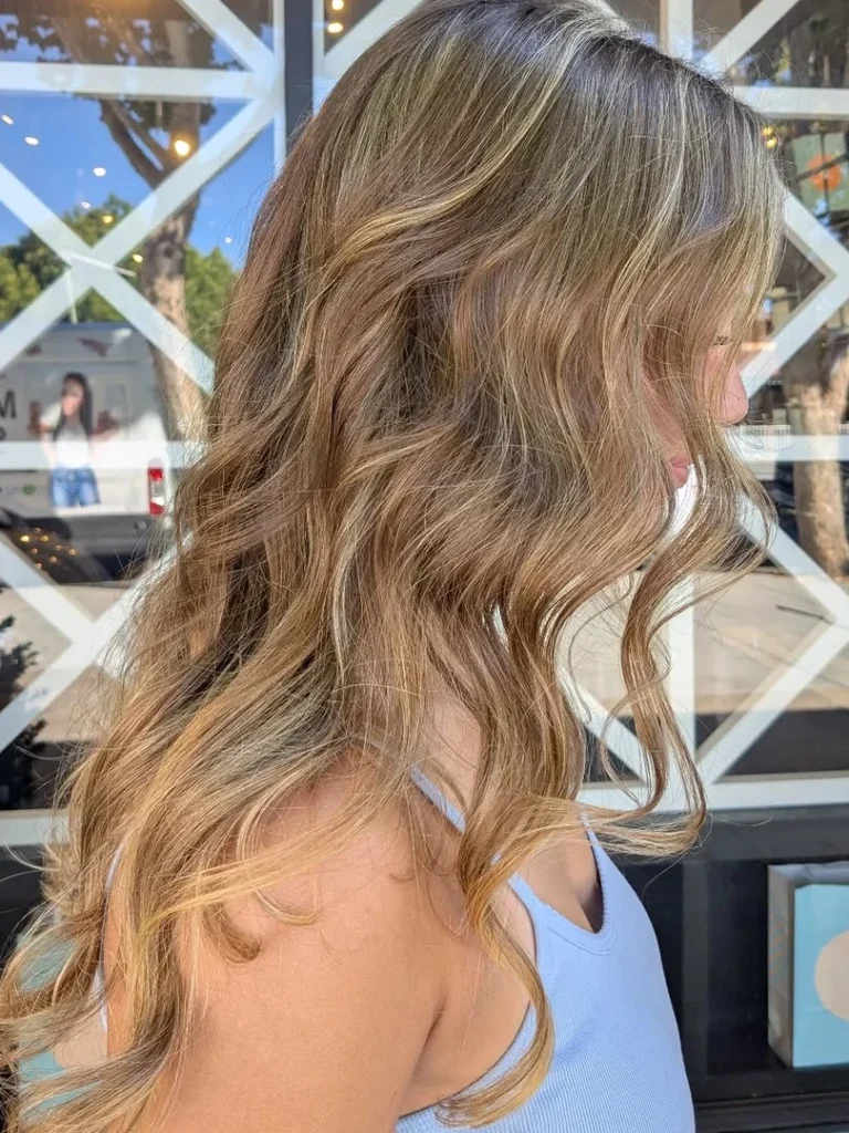 Honey blonde balayage wavy hair