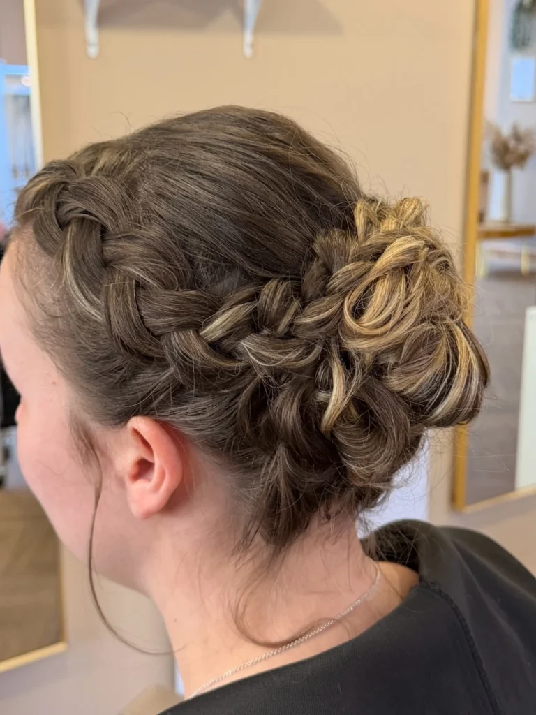 Braided halo updo with a side braid wrapping into a rosette bun