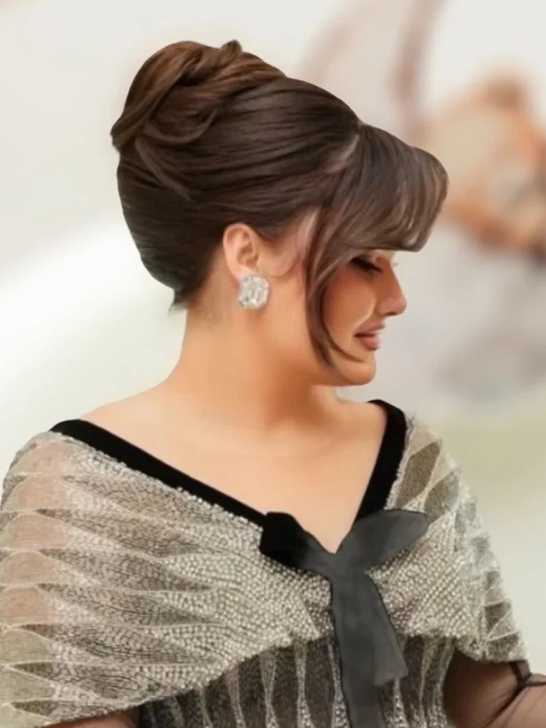 Polished high bun with volume, side profile