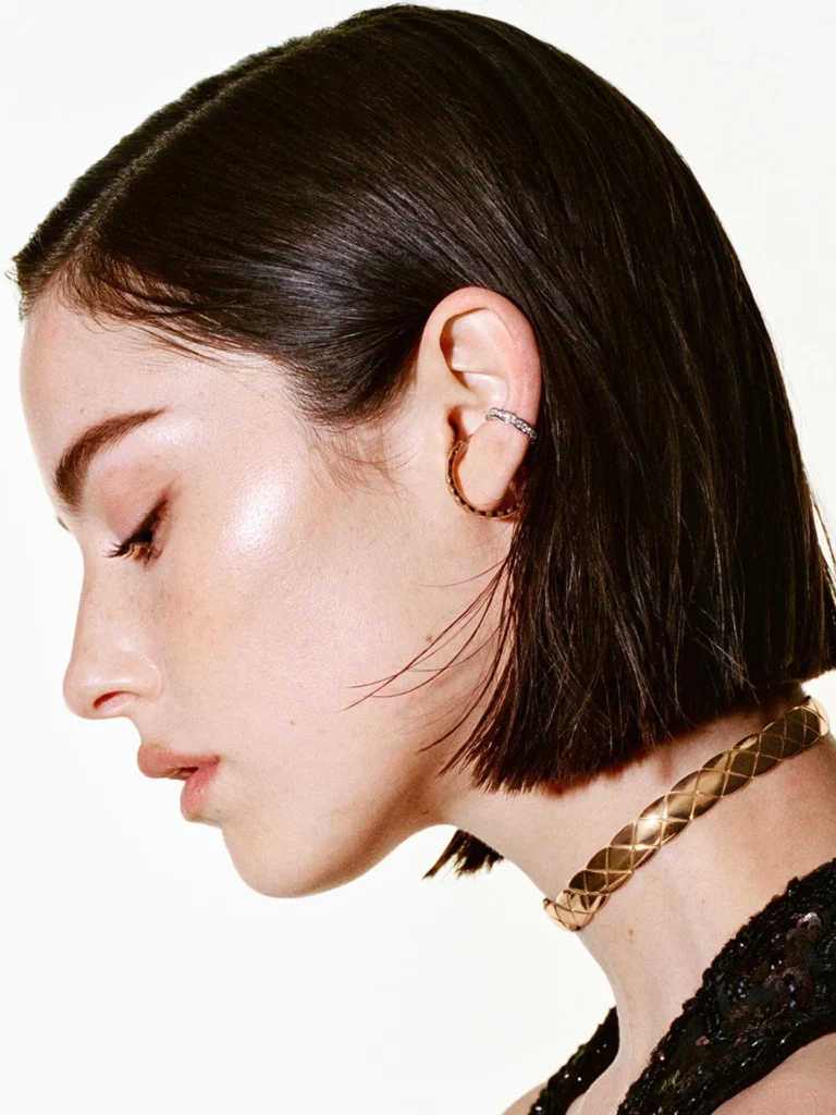 Chin-length sleek bob with a center part, side profile