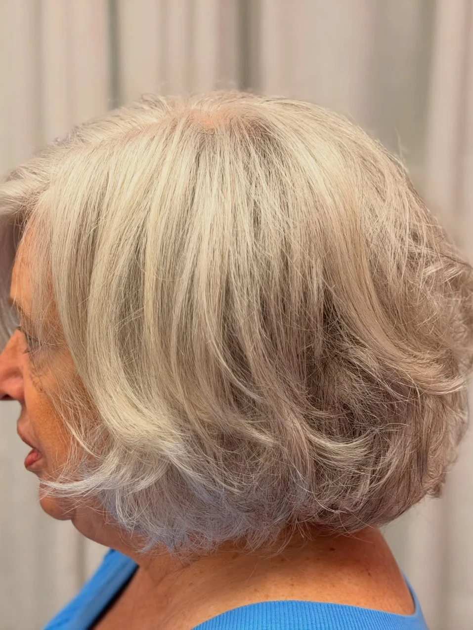 Stacked inverted bob with layered silver blonde hair at the back