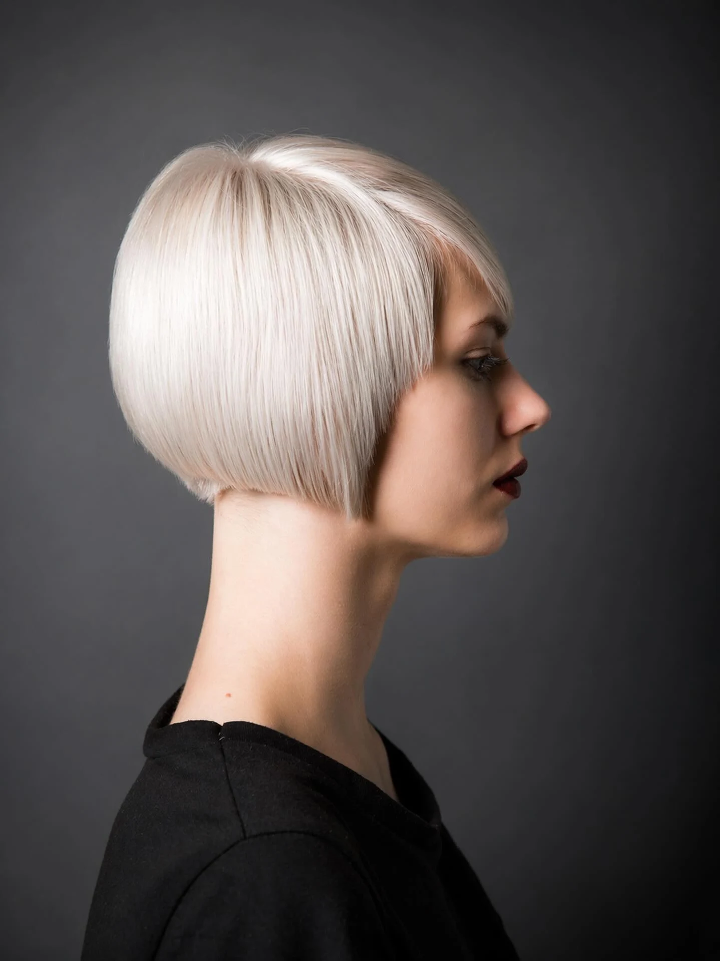 Polished pageboy cut in platinum blonde curving under at the ends