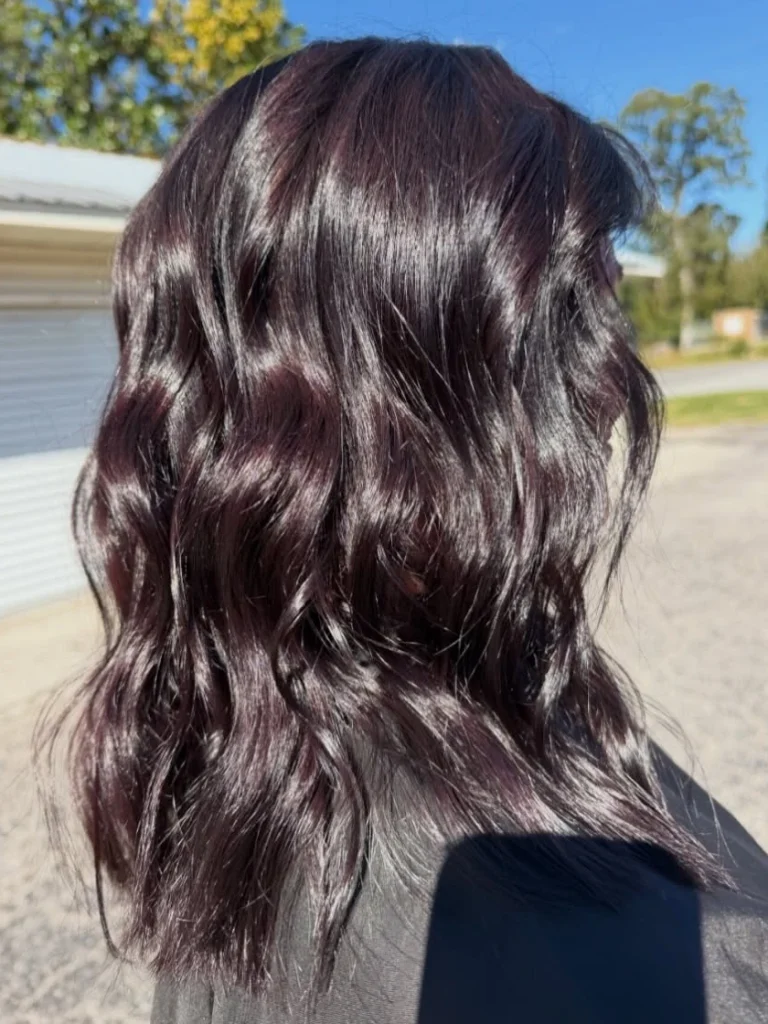 Dark burgundy red wavy hair outdoors