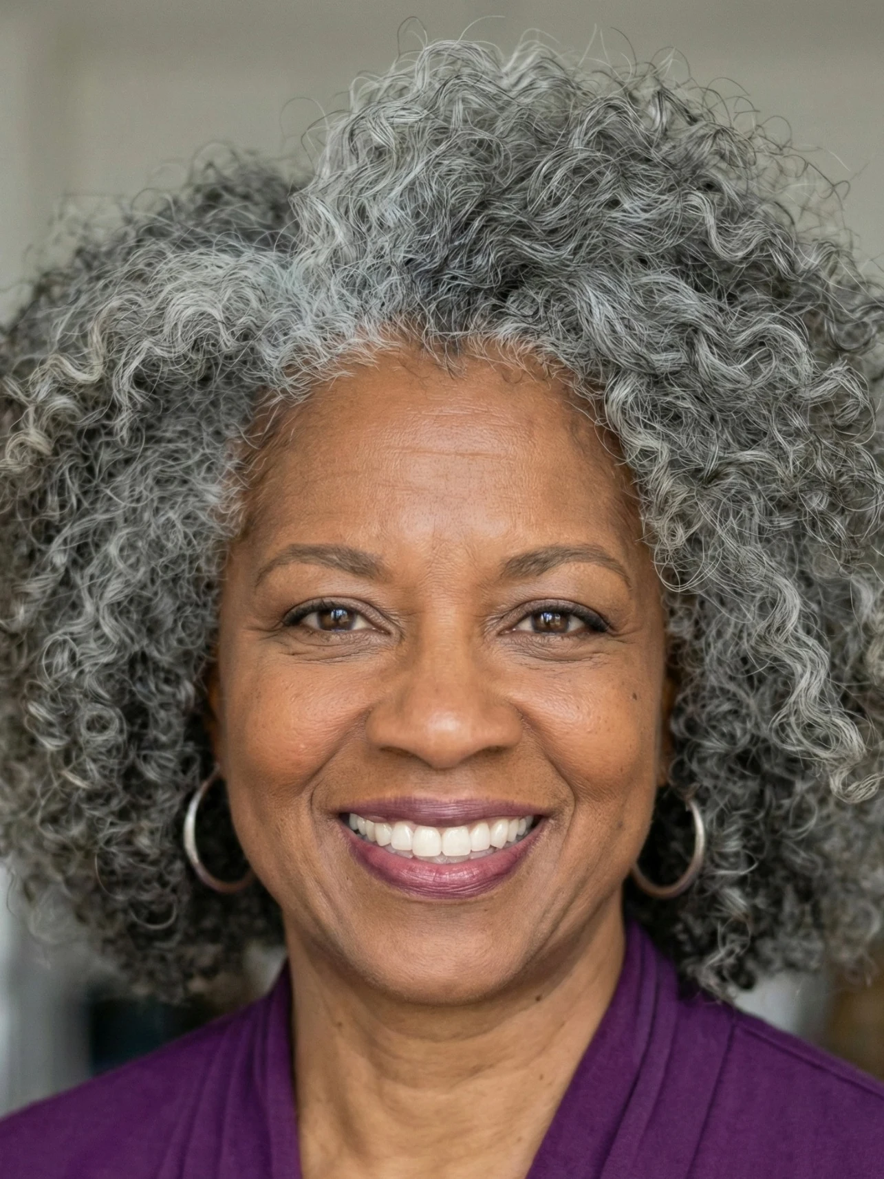 Tapered curly crop with voluminous salt and pepper curls