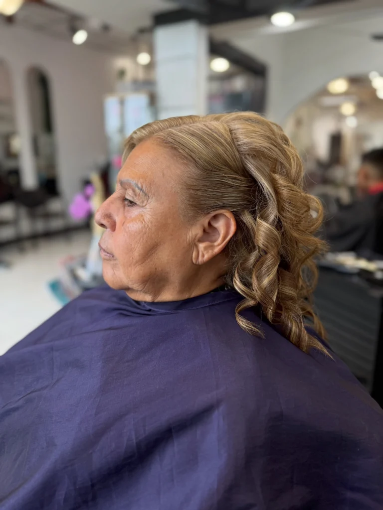 Elegant half-up bouffant with curls on an older blonde woman