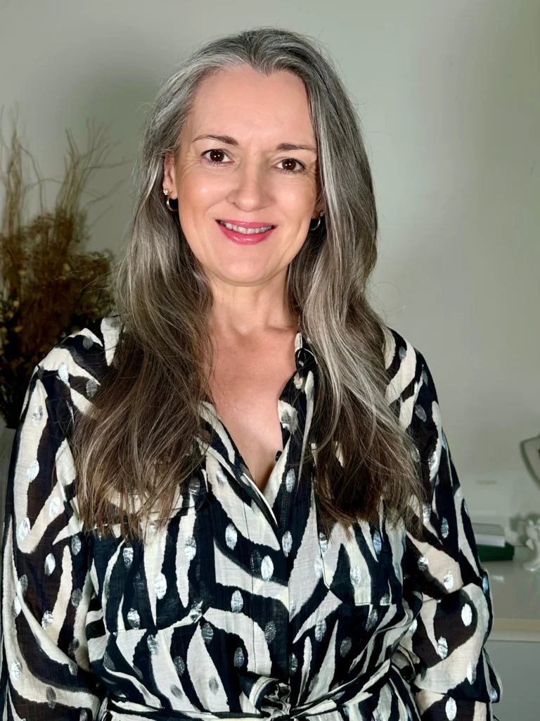 Middle-aged woman with long silver grey hair